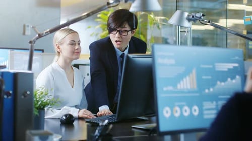 In the Office Businesswoman Sitting at Her Desk Talks with Her Manager, they're pointing at Compute