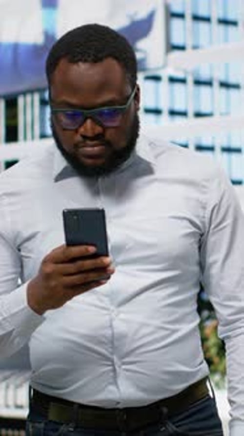 Vertical Video Black Adult Man Navigating on His Phone with Online Map to Walk City Center