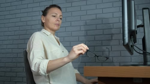 Woman Removes Glasses and Applies Cotton Pads to Eyes
