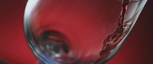 Red Wine Pouring into Glass Close Up
