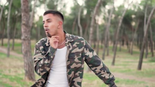 Casual Man Dancing While Facing the Camera in a Park