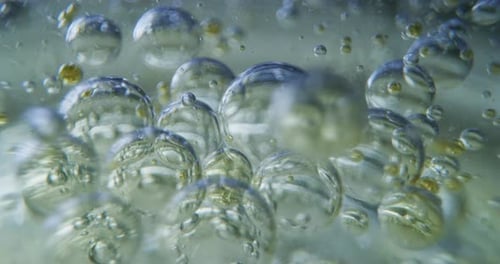 Slow motion macro of micro particles molecules in a liquid are analyzed with microscope for bioche