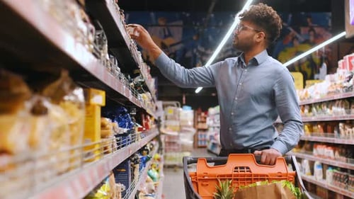 Taking the product. Man is in the grocery store.