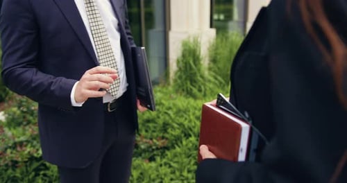 Business People Shaking Hands Outside Modern Office Building