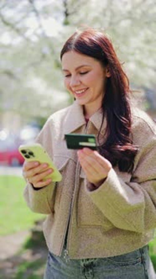 Woman Shopping Online with Phone and Credit Card