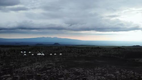 Aerial View of Glamping Domes in Volcanic Landscape Media