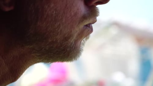 Adult Man Enjoys Food with Beach Backdrop