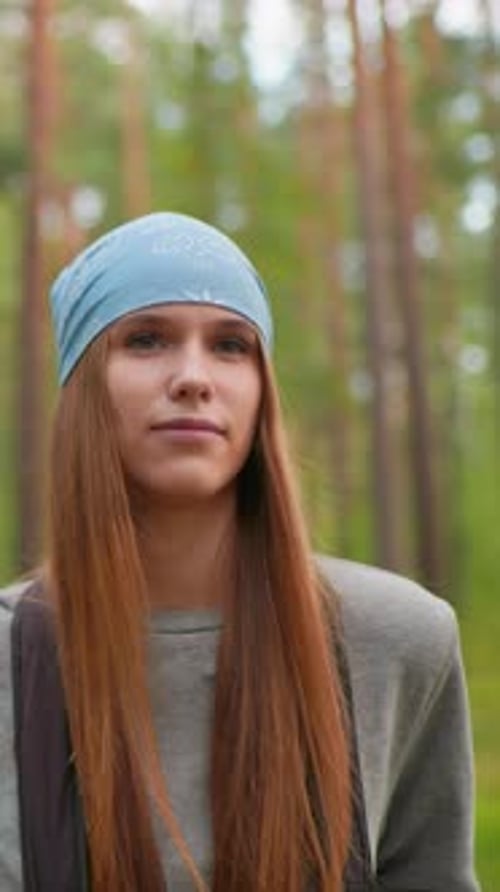 Hikers Walking Through Peaceful Forest Trail with Thoughtful Gaze and Warm Smile