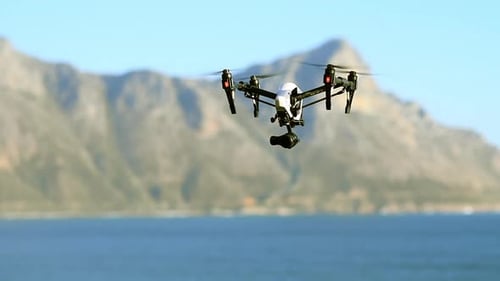 Drone, photography and flight of technology at the beach filming sea landscape with water
