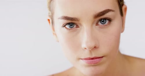 4k video footage of an alluring beautiful woman posing against a studio background