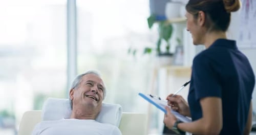 4k video footage of an attractive young female physiotherapist working with a senior male patient