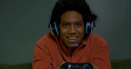 Excited Young Adult Plays Video Game with Controller