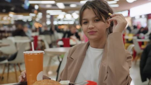 Cheerful Female Dining Confidently in Bustling Mall Setting Brightly Smiling Woman Confidently Eats