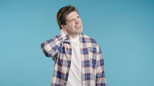 Man Rubbing Neck in Painful Discomfort