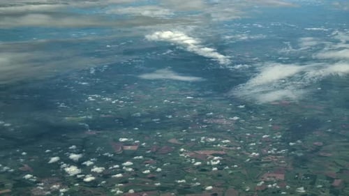 Scattered Clouds Above a Green Landscape - High Altitude Aerial View