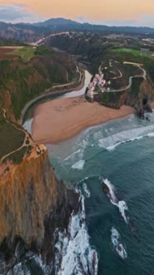 Aerial View of Small Village with Windmill and Picturesque Rooftops Odeceixe Portugal