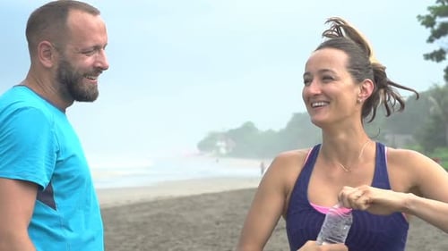 Couple Resting, Drinking Water After Jogging on Beach, Super 240