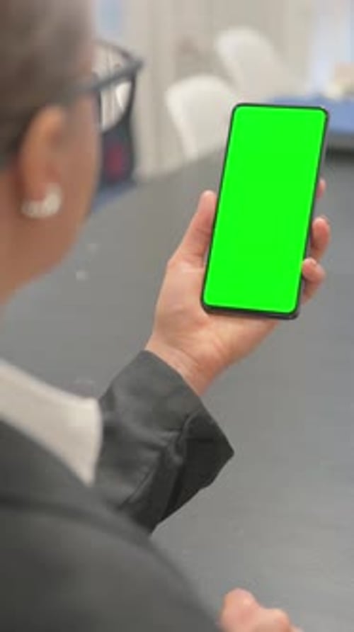 Rear View of Business Woman with Green Screen Smartphone, vertical video