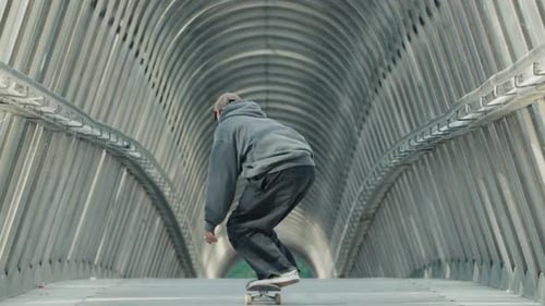 Young Man Performing Skateboard Kickflip Trick in Slow Motion