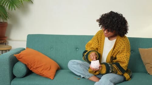 Saving Money Investment for Future African American Girl Holding Pink Piggy Bank and Putting Money