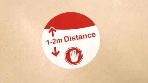 Coronavirus Warning sign on grocery store floor 1-2M social distance.