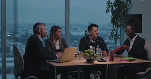 Diverse businesspeople in meeting at office building