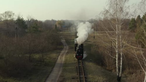 Aerial View of Old Steam Train Running on the Tracks in the Countryside