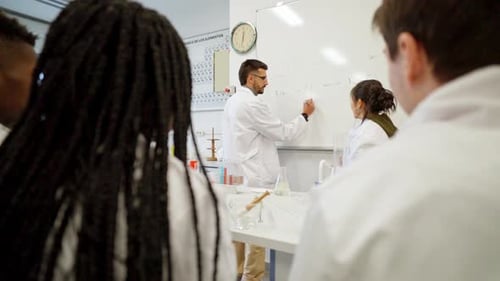 Teacher Explains Science to Students in Modern Lab