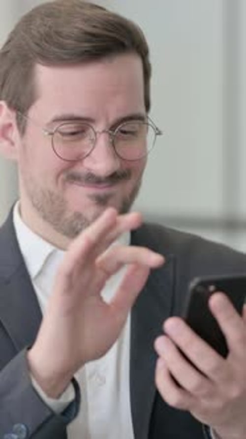 Happy Man in Suit Using Mobile Phone