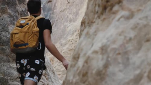 Man hiking through rocky canyon