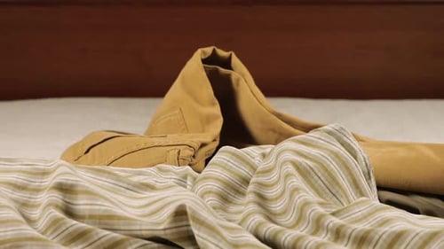Pile of Clothing Thrown on Bed