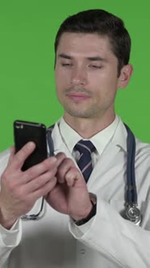 Ambitious Young Doctor using his Cellphone, Chroma Key, vertical video