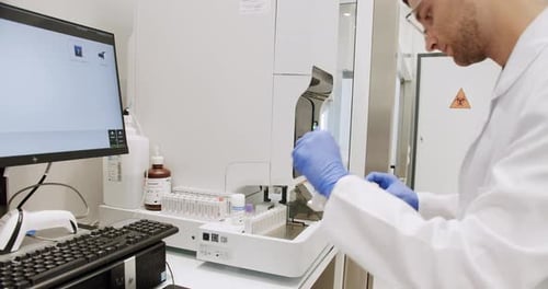 Scientist Analyzing Vials in Bright Medical Laboratory