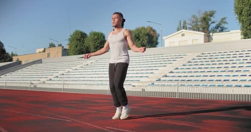 Cardio Workout Young African American Athlete Skipping with Jump Rope on a Race Track at Stadium
