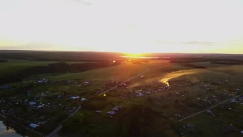 Breathtaking Aerial View of a Beautiful Sunset Over a Calming Rural Landscape Scene Stock Clip
