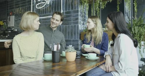 Group of Friends Having Fun in Cafe, Drinking Hot Beverages, Talking and Sharing.