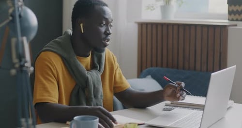 Man working at computer at desk inside home