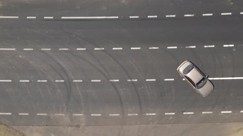 Aerial View of City Street with White Markings and Fast Driving Cars Top View From Drone of Urban