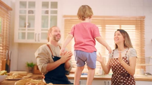 Happy Family Dancing Together in the Kitchen