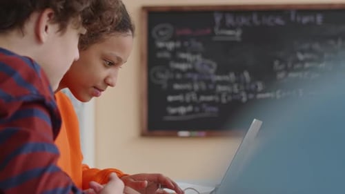 Students Collaborating on Laptop in Classroom