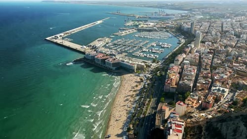 Aerial drone view of the Port of Alicante and the buildings in the city in daylight