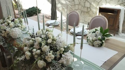 Elegant Wedding Reception Table with Flowers and Candles