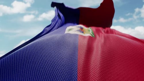 Realistic Waving Haiti Flag Against Blue Sky with Clouds