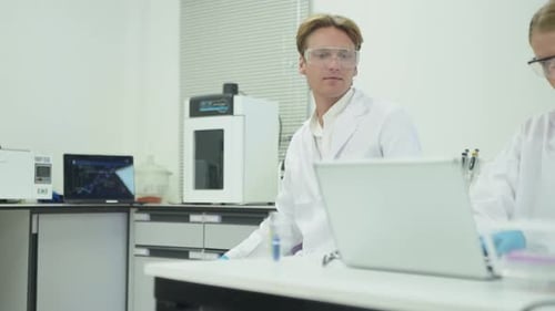 Researchers conduct experiments in laboratory with microscopes and samples