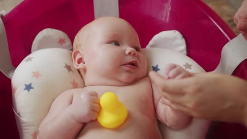 Mother Playing with Her Baby in a Bathtub Shallow Depth of Field