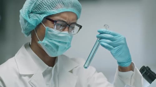 Woman Scientist Examining Test Tube in Laboratory