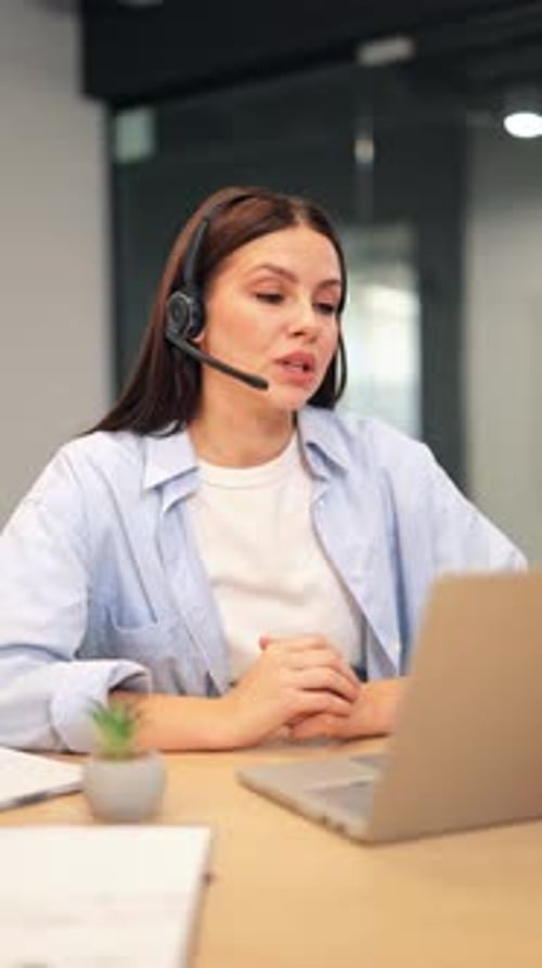 Focused Professional Woman Wearing Headset on Video Call at Office