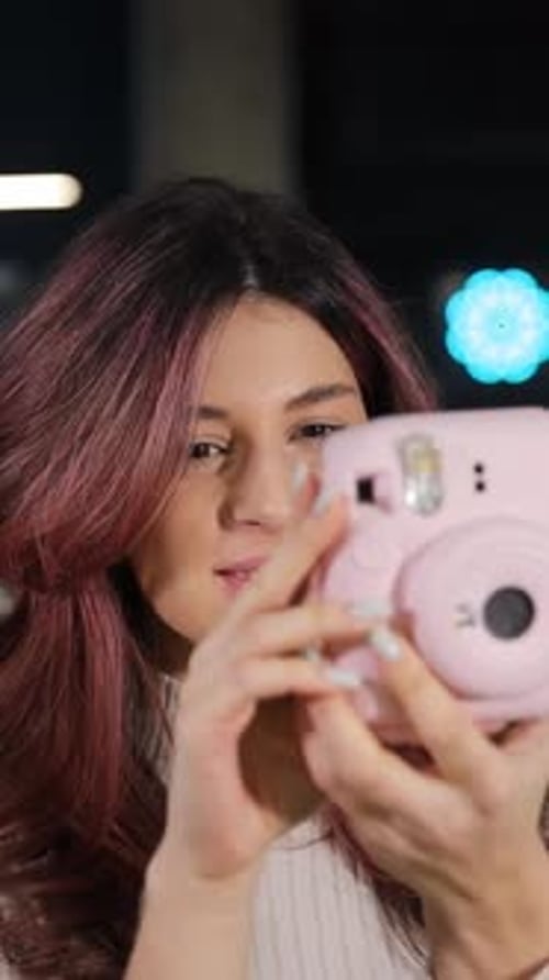 Vertical Video Smiling Girl Chooses Digital Camera in Digital Store