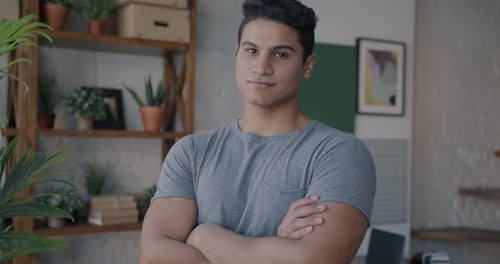 Young Adult Posing Indoors with Arms Crossed