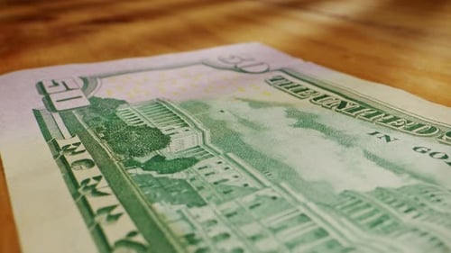 CloseUp of a Fifty Dollar Bill on a Wooden Surface Highlighting Its Intricate Designs